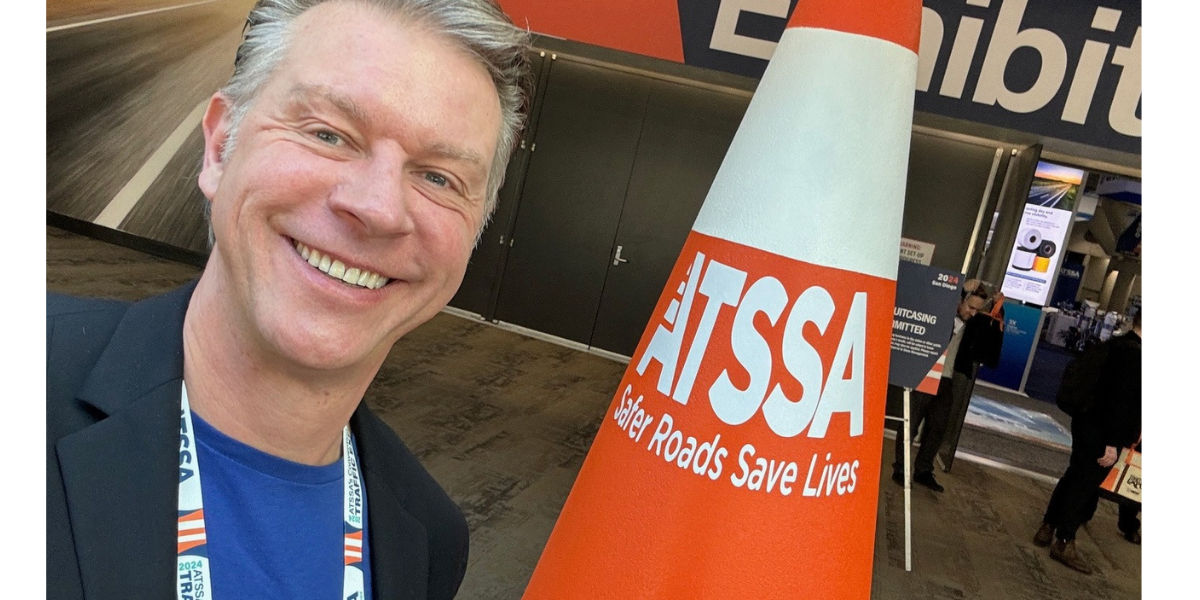 Greg at the ATSSA show in front of the cone.