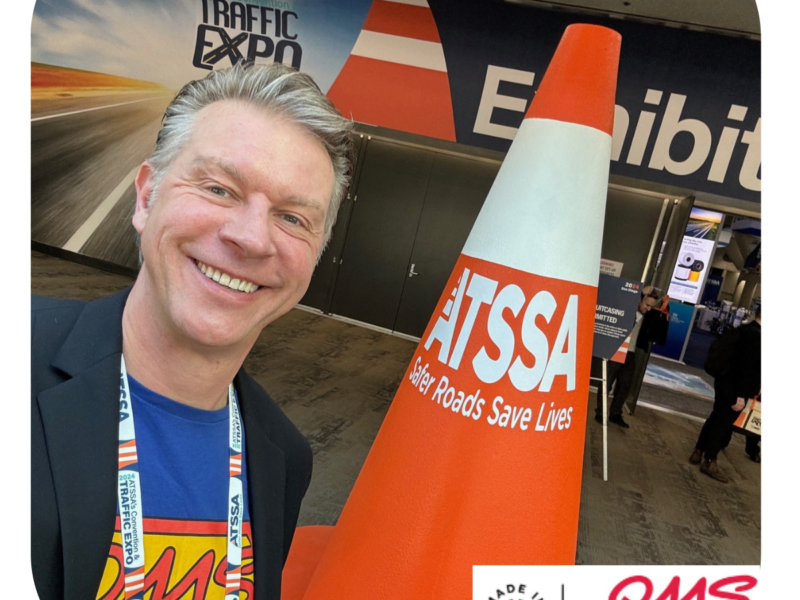 Greg at the ATSSA show in front of the cone.