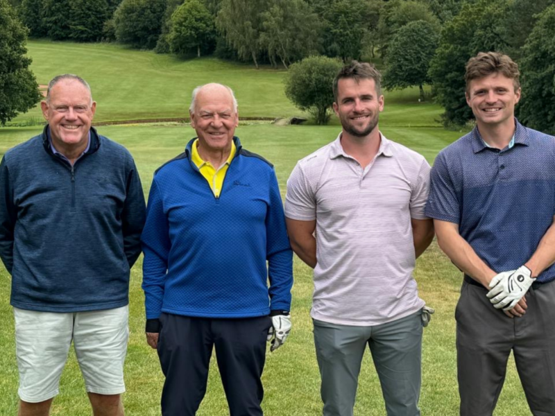 Group of four in front of fairway