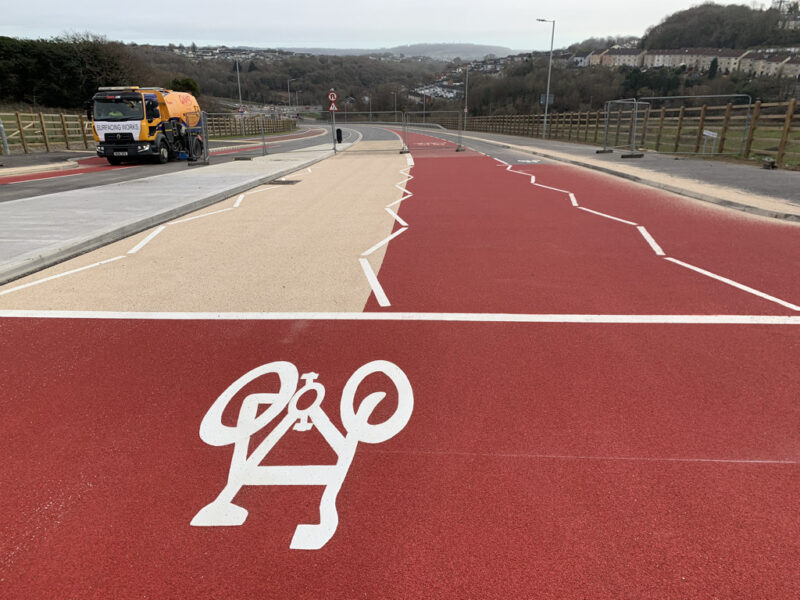cyclist marking on red and cream road