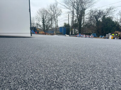 Grey resin bound pathway with residential property in background