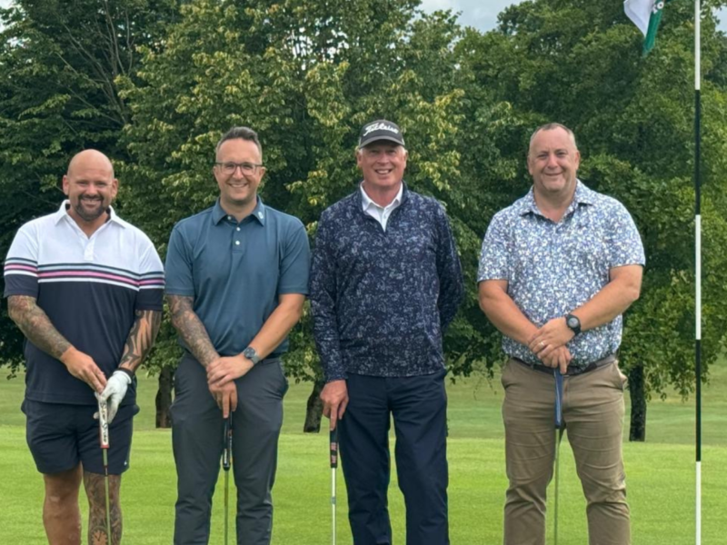group of four by hole on the green