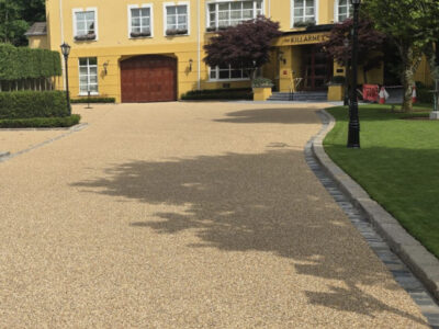 Resin bound driveway with landscaping and green lawn
