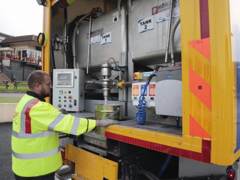 QMS team member with vehicle