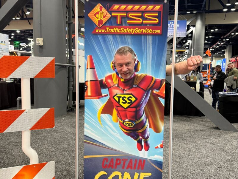 Greg standing in a cut out of Superman from TSS