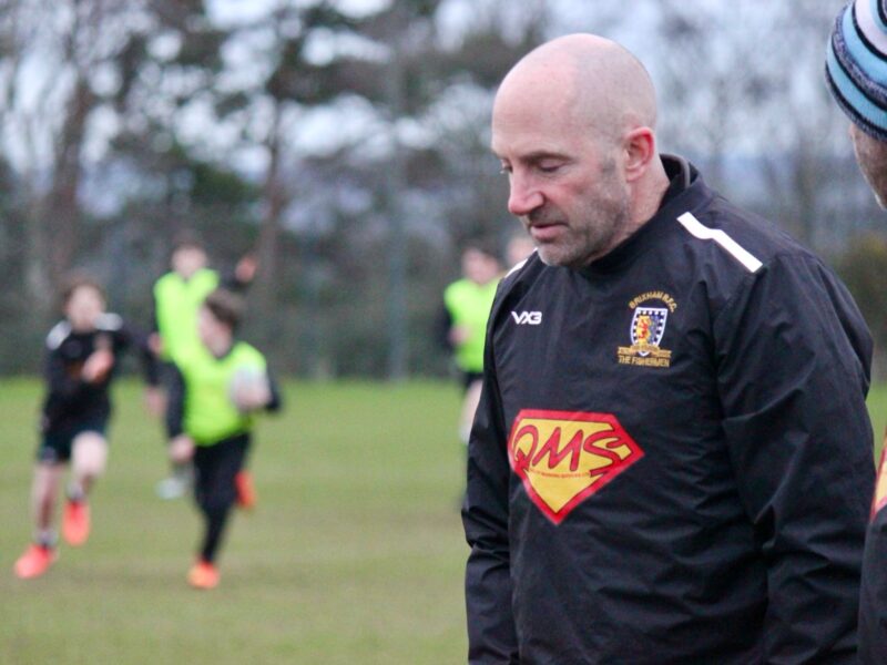 Close up of QMS branding on Brixham U14s Rugby Club kit