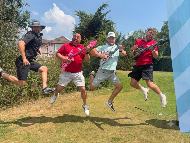 Karaoke fairway to devon 2026 team photo with inflatable guitars