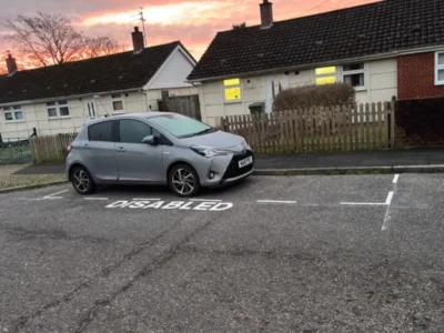 Disabled parking bay and white bay lines marked out in MMA road marking paint on a residential street